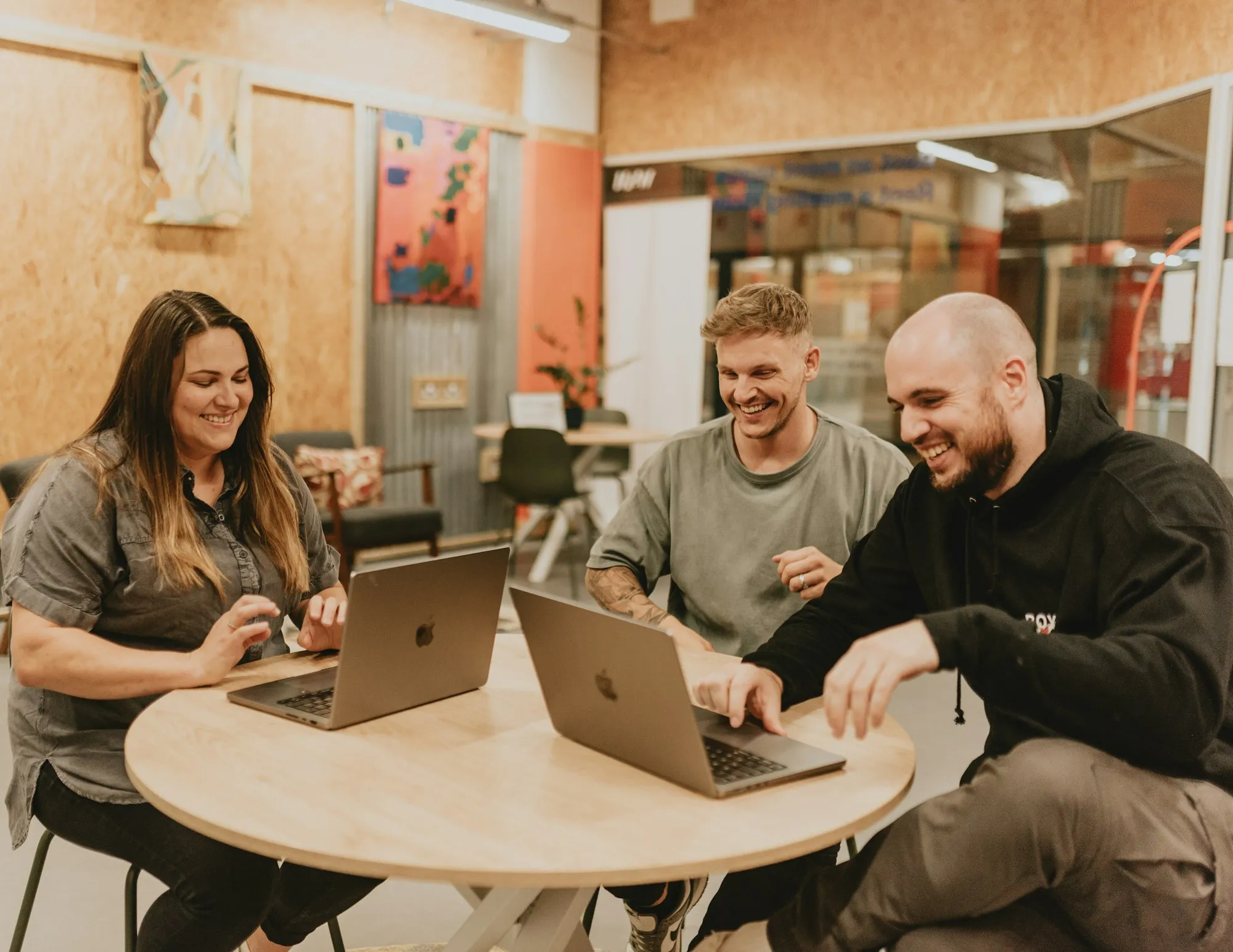 Team working together around a table with laptops