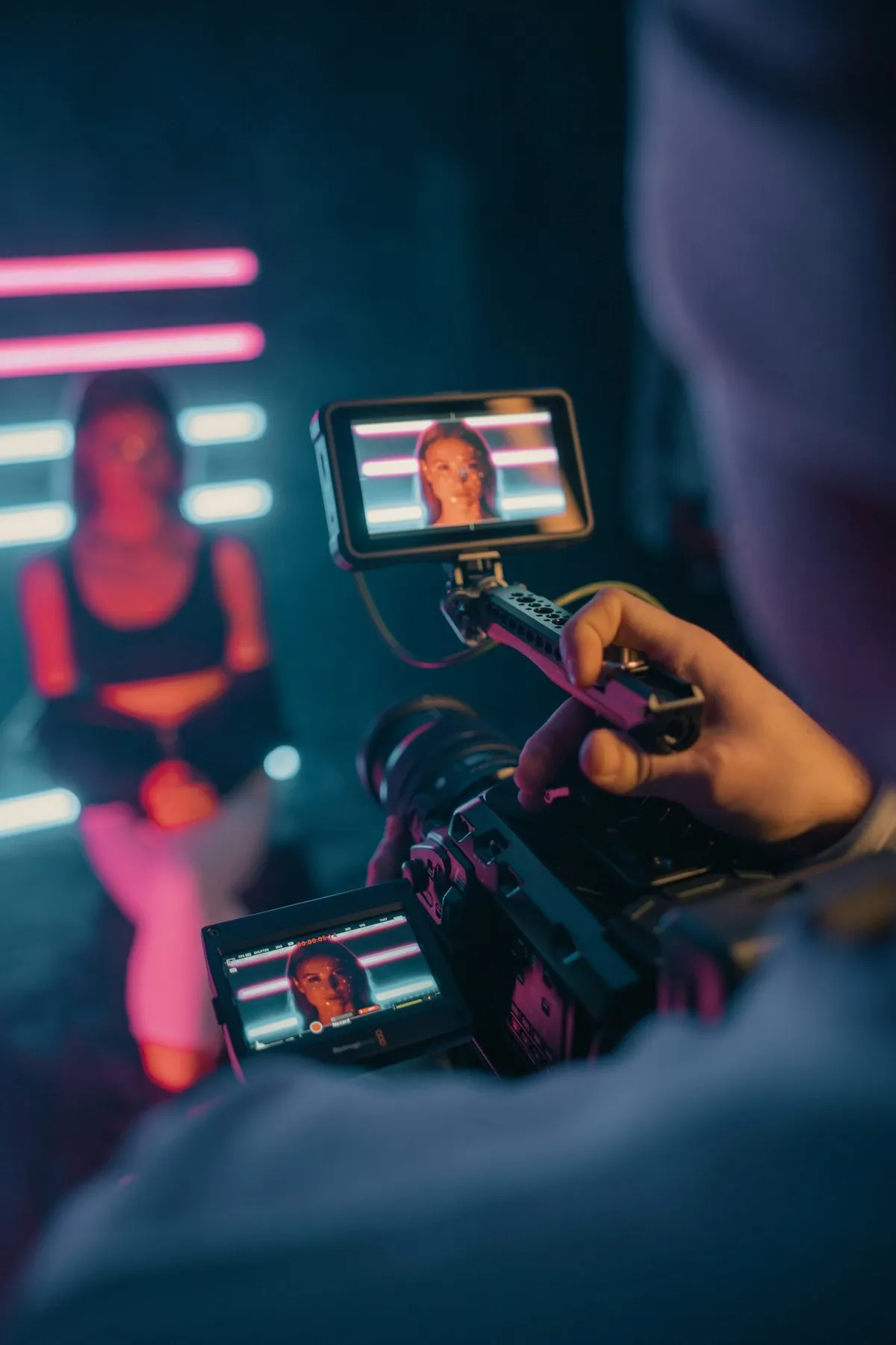 Camera rig filming a creator under neon light